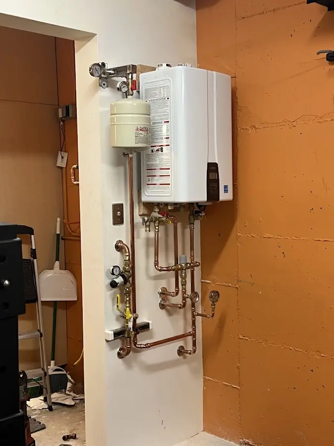 Plumbing technician inspecting water heater connections in Vero Beach